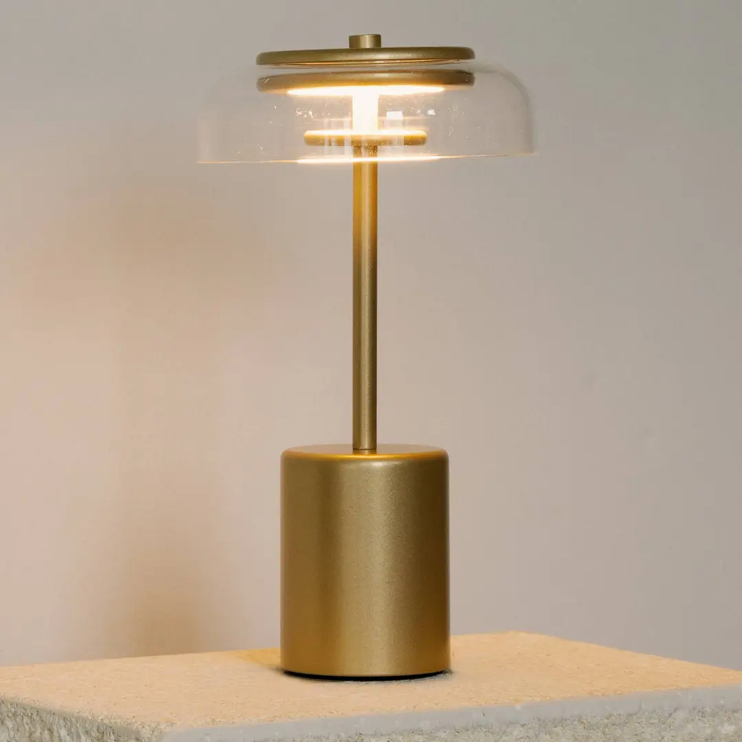Nuura LED-Akku-Tischlampe Blossi, Höhe 26 cm goldfarben/klar